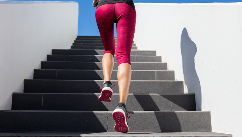 Woman running up stairs for cardio workout