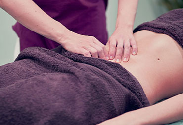 Woman receiving myofascial release on stomach