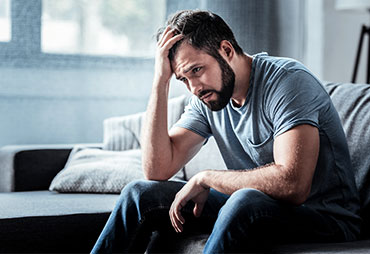 Man struggling with stress at home